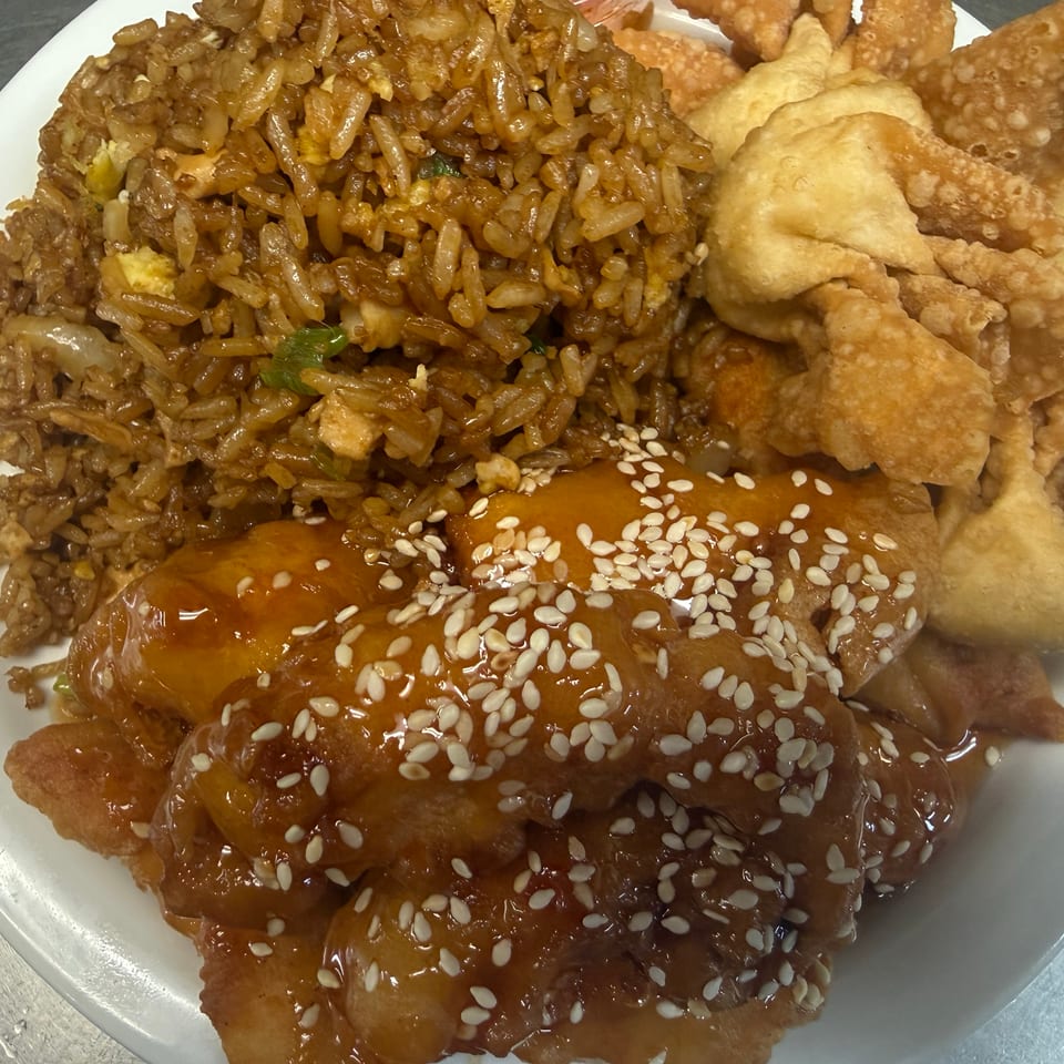 Plate of fried rice, sesame-glazed fried chicken, and crispy fried wontons.
